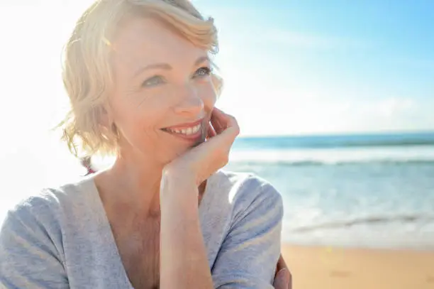 Photo of Beautiful mature woman portrait on the beach