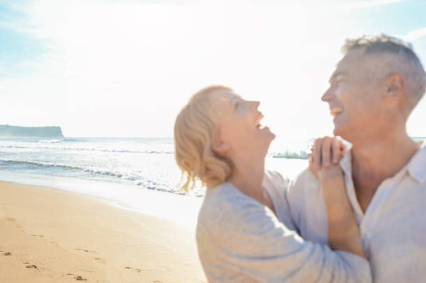 istock Affectionate mature couple embracing at the beach. 987105374