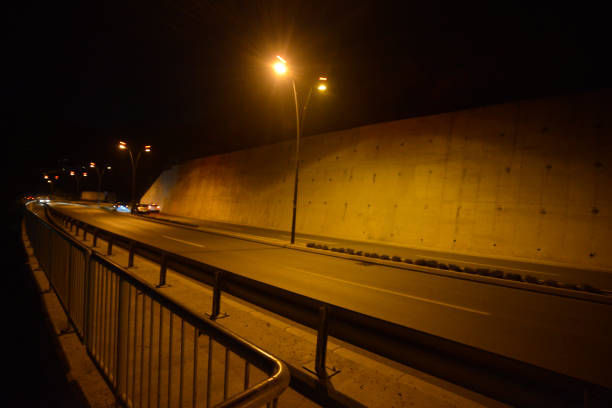 Multiple lane highway with pedestrian sidewalk at night