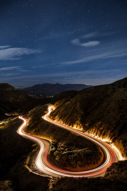 Winding Roads at Night Long exposure of a road in Los Angeles. winding road mountain stock pictures, royalty-free photos & images