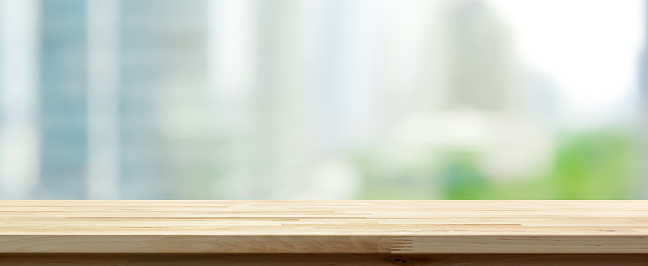Wood table top on abstract blurred cityscape banner background - can be used for display or montage your products