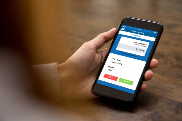 istock Woman looking at smartphone screen while transferring money online 987130366