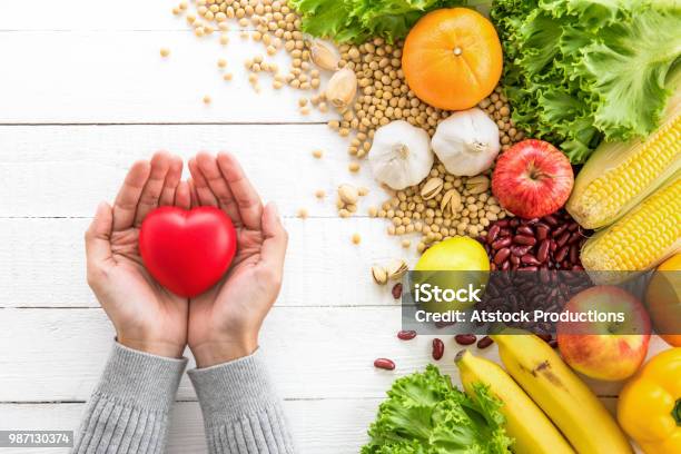 Woman Hands Showing Red Heart Ball With Healthy Food Aside Stock Photo - Download Image Now