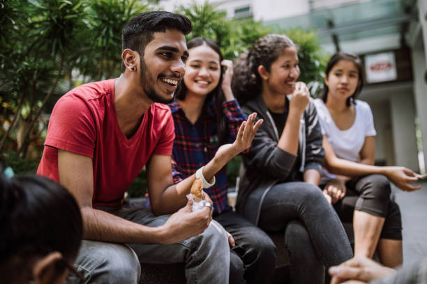 Group Of Students Joking And Getting To Know Each Other Multi Ethnic Group Of Students Joking And Getting To Know Each Other Better On Lunch Break in University Yard indian ethnicity stock pictures, royalty-free photos & images