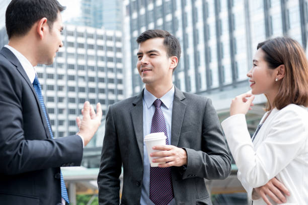 istock Business people standing and talking outside office 987130614