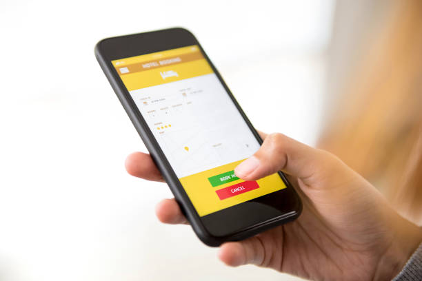 istock Woman booking hotel online via smart phone application 987130730