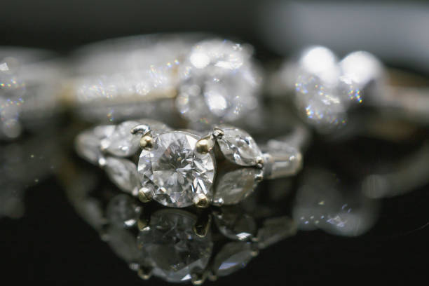 istock Luxury Jewelry diamond rings with reflection on black background 987138674