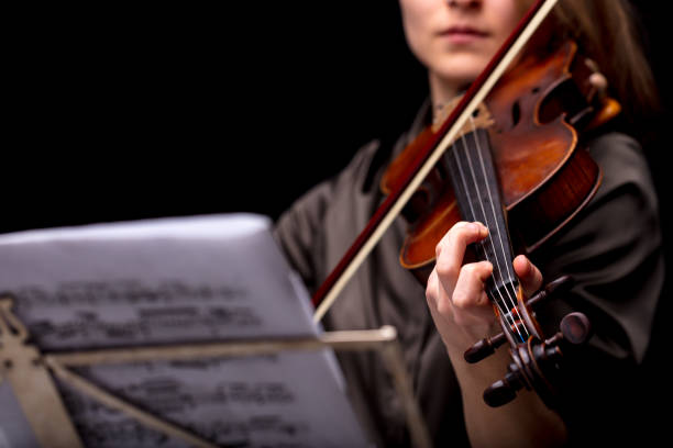 istock violinist playing in front of her score 987165656
