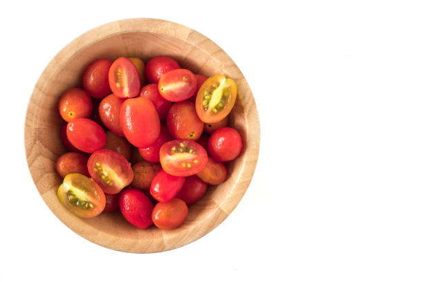 istock Plum tomatoes in wooden bowl on white background. copy space 987171510