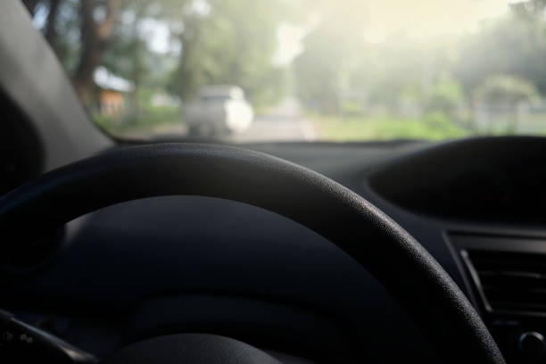 istock Driver on the steering wheel inside of a car 987171962