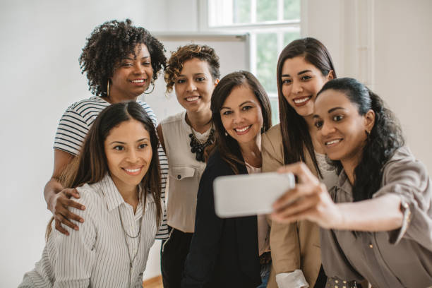 istock Women coworkers making selfie 987181416