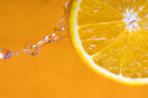 Orange with water on orange background