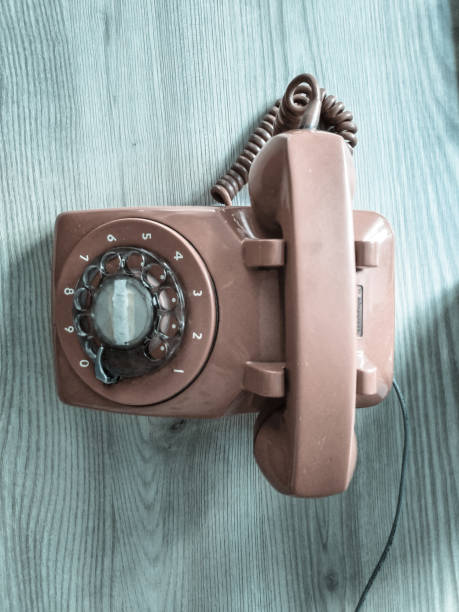 istock old retro style red phone on the wooden table 987209368