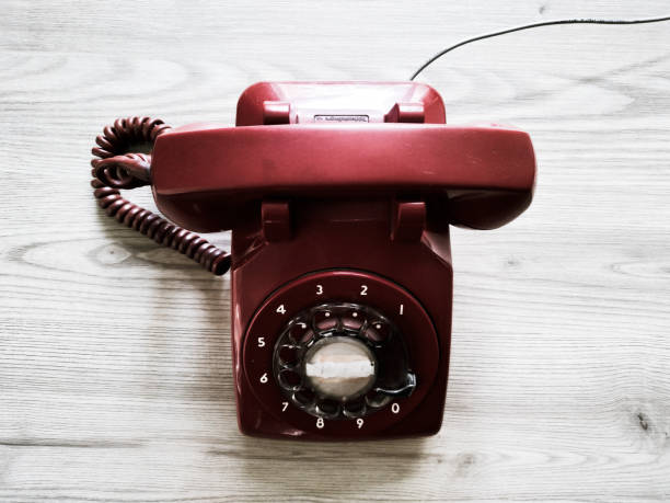 istock old retro style red phone on the wooden table 987212636