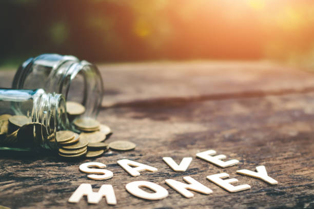 istock Putting coins in jar with money stack step growth saving money, Concept finance business investment 987216358