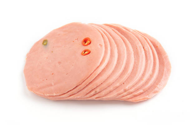 istock Boiled sausage slices isolated on white background. 987220204