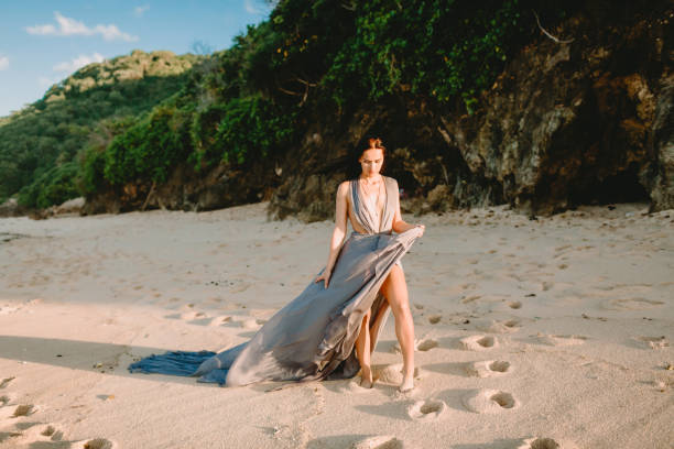 istock Attractive bride in stylish blue dress at beach 987225304