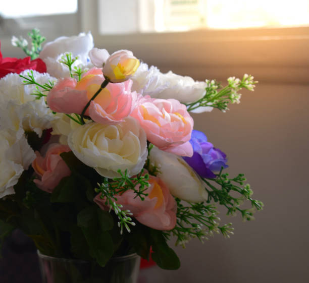 istock Beautiful flower on the table near the window 987231868