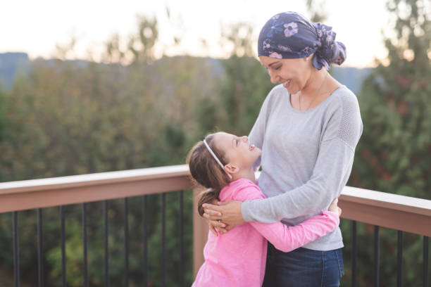istock Mother with cancer hugging her daughter 987237250