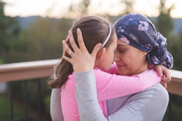 istock Mother with cancer hugging her daughter 987237254