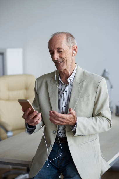 Videocall Cheerful entrepreneur having videocall with business partner vietnamese old man portrait stock pictures, royalty-free photos & images