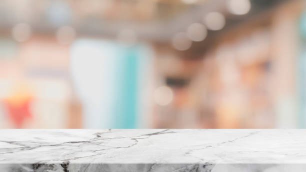 istock Empty stone table top on blurred with bokeh shopping mall background - can be used for display or montage your products 987252582