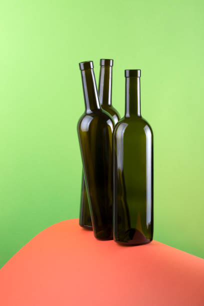 istock Abstract still life with color background and three glass bottles 987253548