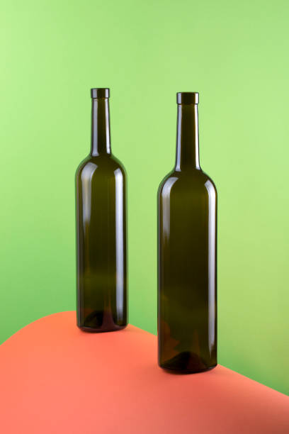istock Abstract still life with color background and two glass bottles 987253562