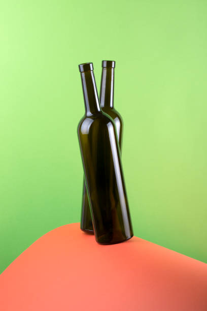 istock Abstract still life with color background and two glass bottles 987253594