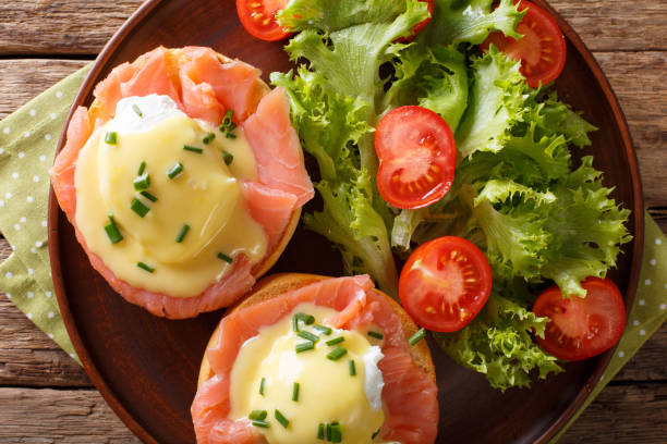 istock Eggs Benedict with salmon and hollandaise sauce close-up. horizontal top view 987290294