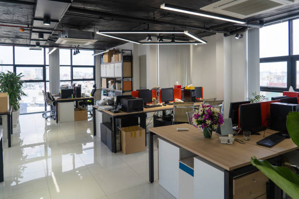 istock Modern office interior with wooden tables 987290724