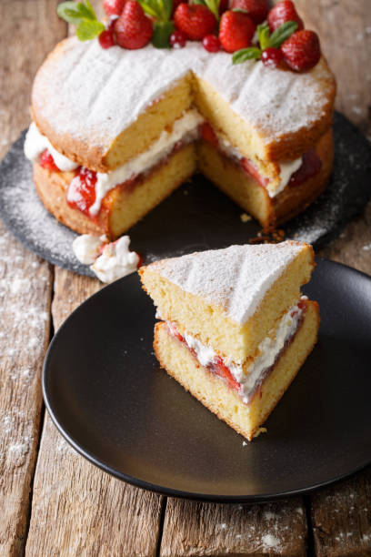 Sliced Victoria sponge cake closeup on a plate. vertical