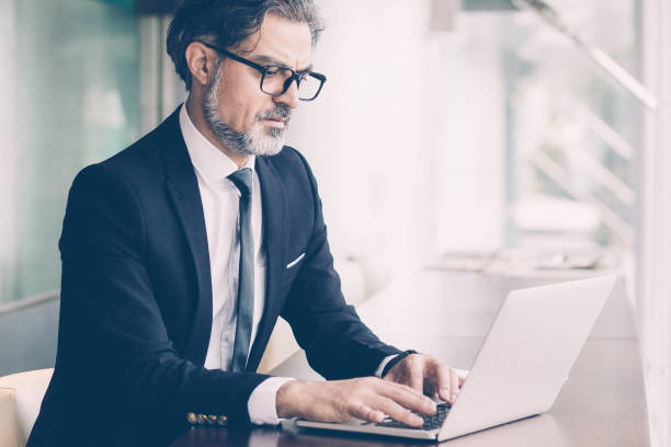 istock Concentrated senior man typing on laptop 987298346