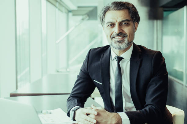 istock Portrait of successful financier at paperwork 987298490