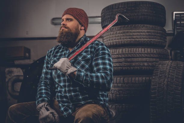 istock A man sits on an old tire in a garage. 987298774