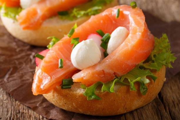 istock Delicious sandwich with salmon, mozzarella cheese and radish close-up. horizontal 987301338