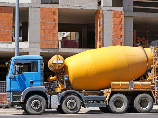 istock Cement mixer truck next to a construction site 987301750