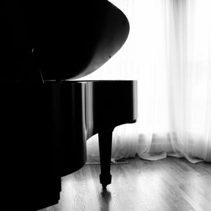 Grand piano on white background, top view. classic black piano on stage