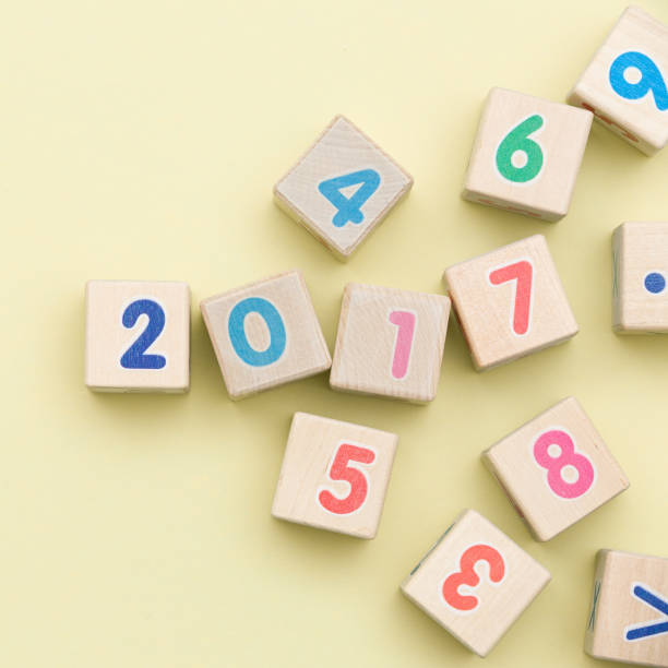istock Wooden cubes with numbers on light green background 987310896
