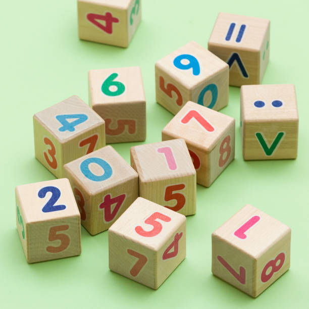 istock Wooden cubes with numbers on light green background 987310990
