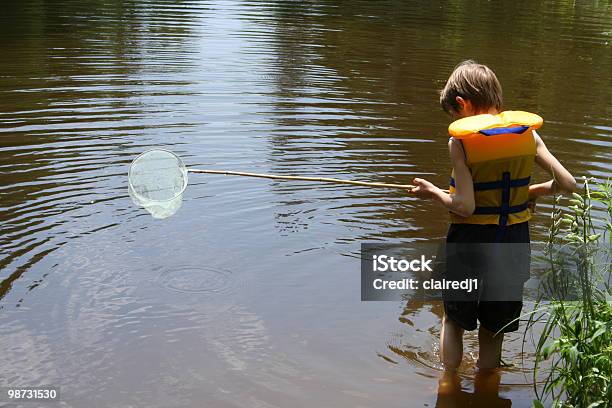 Boy Fishing With Net Stock Photo - Download Image Now - Child, Life Jacket, River