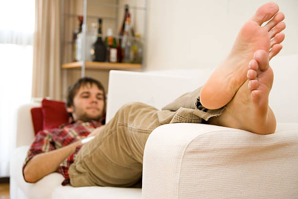 Man relaxing on the sofa stock photo