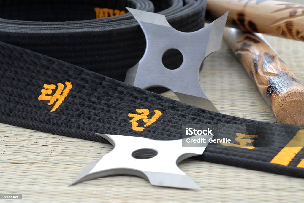 Training weapons Tae Kwon Do black belt, ninja, stars, and escrima sticks. Black Belt Stock Photo