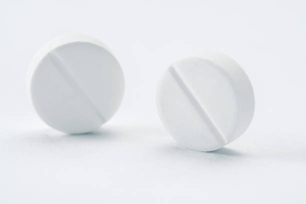 istock White pills and tablets isolated on white, closeup 987334010
