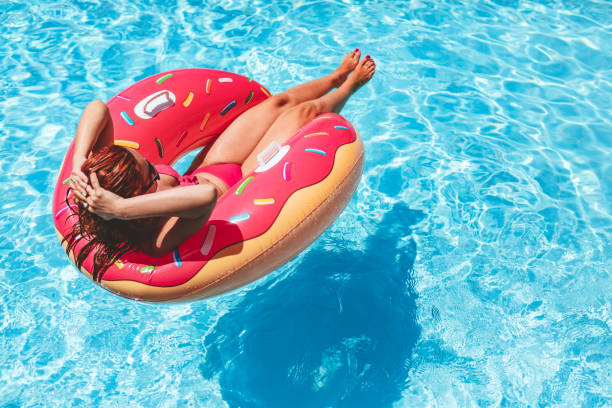 istock Woman relaxing on inflatable ring 987338432