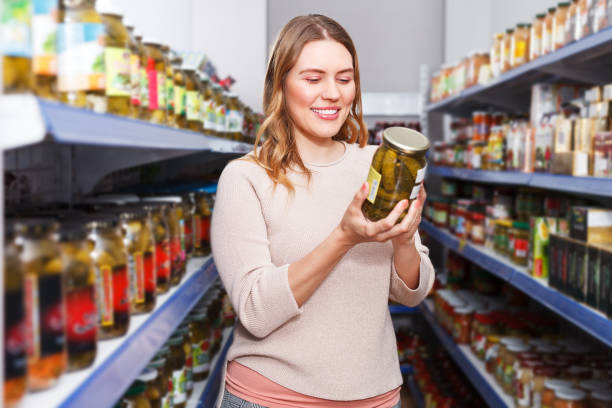 istock Woman choosing pickle goods 987341714