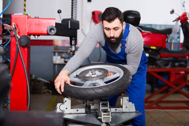 istock Man 20-30years old is working at restoring wheel 987342228