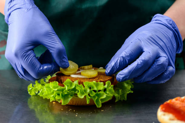 istock Unidentified chef preparing delicious juicy burger 987343148