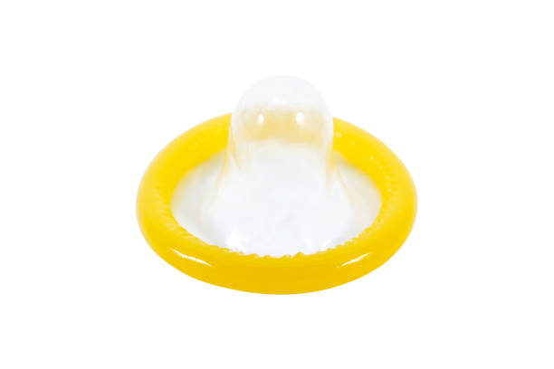 istock Yellow condom isolated on white background 987344040