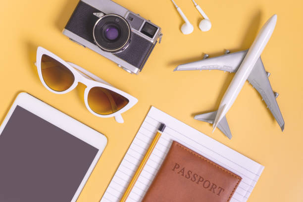 istock Travel objects flat lay on yellow background for travel concept 987344190